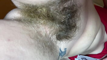 Close up of a hairy pussy bush in a solo homemade vid